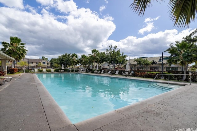 pool with a residential view and fence