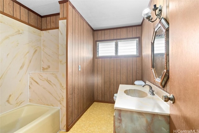 bathroom featuring vanity, wooden walls, and a bathing tub