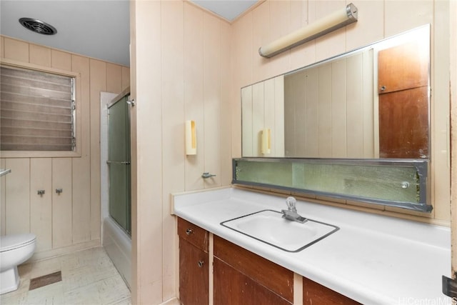 full bathroom with toilet, vanity, and shower / bath combination with glass door