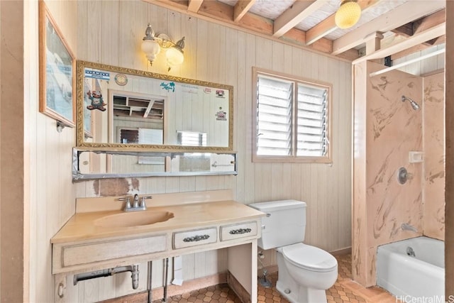 bathroom featuring sink, wood walls, and toilet