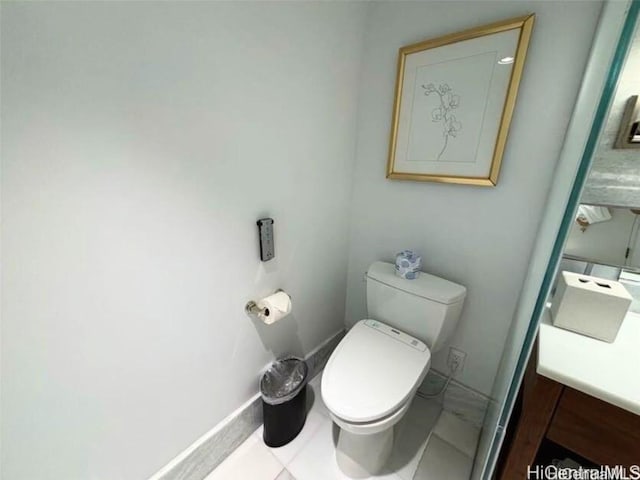 bathroom featuring vanity, toilet, and tile patterned flooring