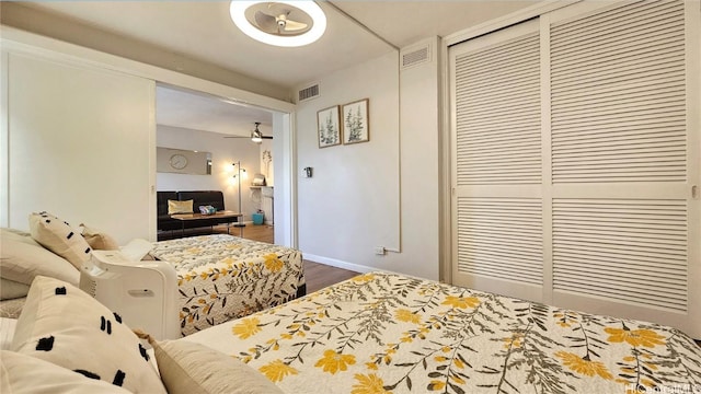 bedroom with wood-type flooring and a closet