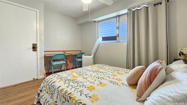 bedroom with light hardwood / wood-style floors and ceiling fan