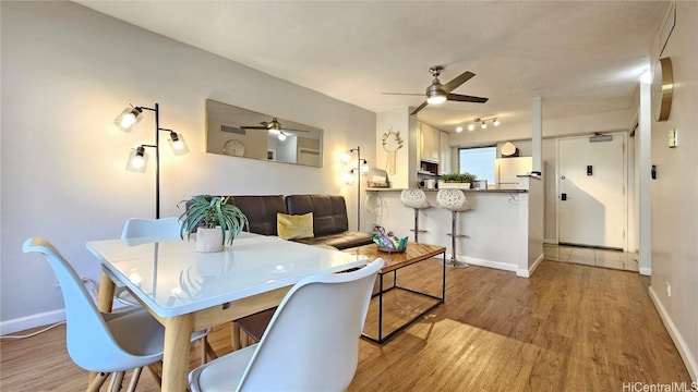 dining space featuring ceiling fan and light hardwood / wood-style flooring