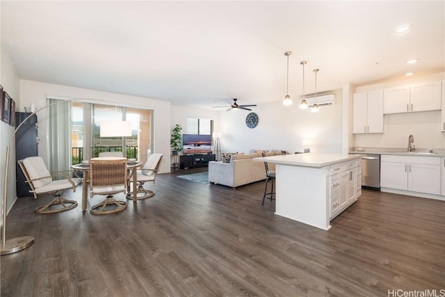 kitchen with sink, decorative light fixtures, a center island, dishwasher, and white cabinets