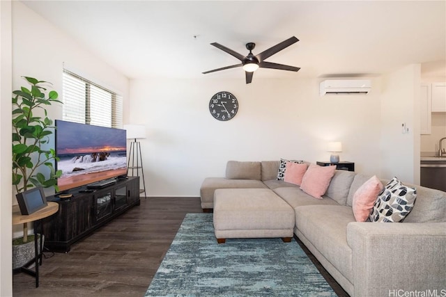 living room with sink, dark wood-type flooring, an AC wall unit, and ceiling fan