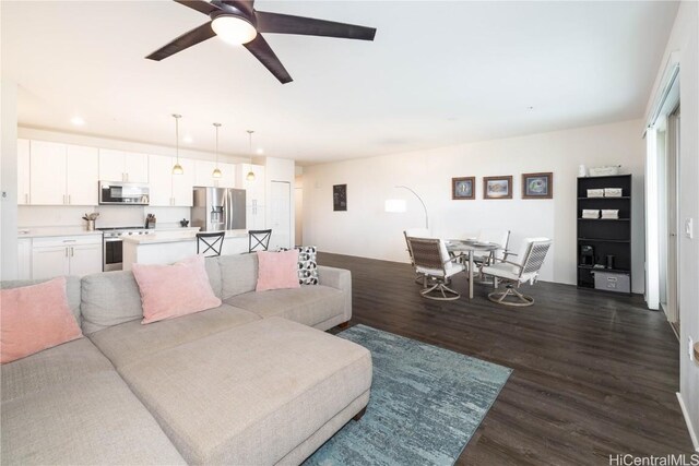 living room with dark hardwood / wood-style floors and ceiling fan