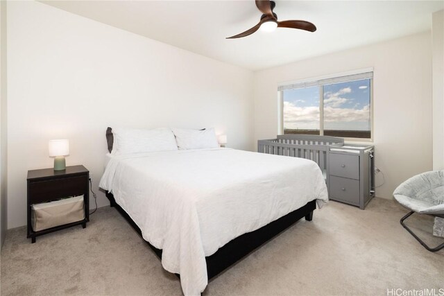 bedroom with light carpet and ceiling fan