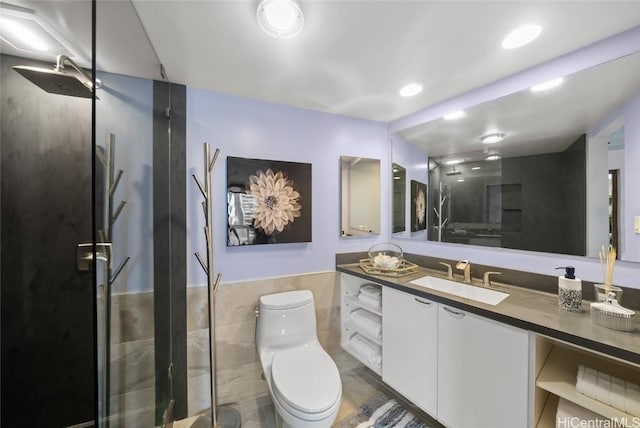 bathroom featuring vanity, a shower with shower door, tile walls, and toilet