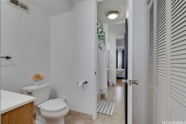 bathroom with tile patterned floors, vanity, and toilet