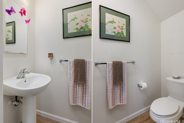 bathroom with hardwood / wood-style flooring, toilet, and sink