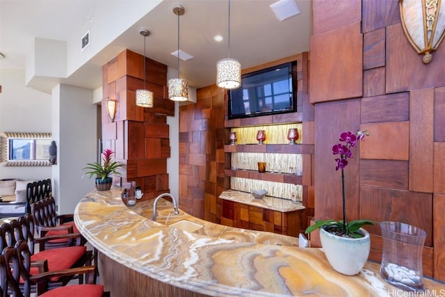 bar with sink and hanging light fixtures