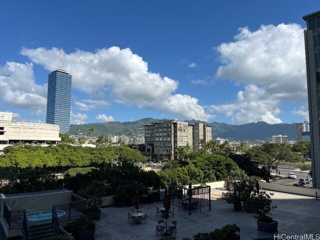 view of community featuring a mountain view and a patio