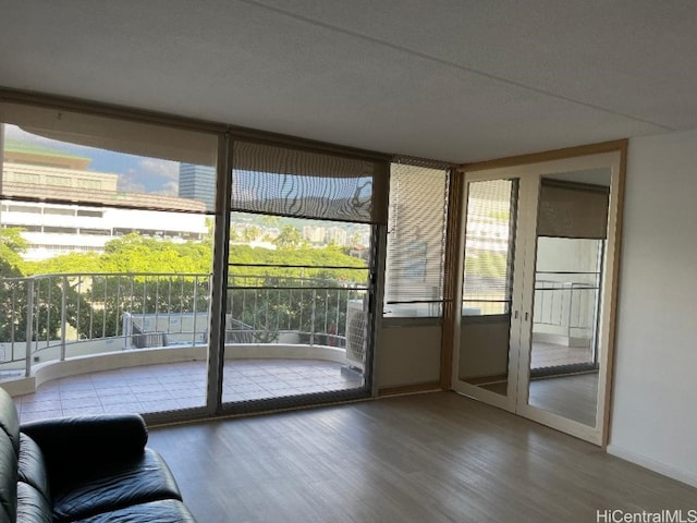 entryway with hardwood / wood-style flooring and expansive windows