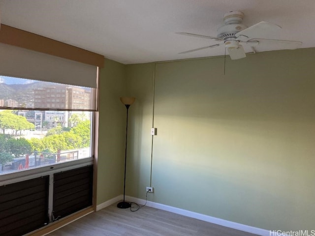 spare room featuring hardwood / wood-style floors and ceiling fan