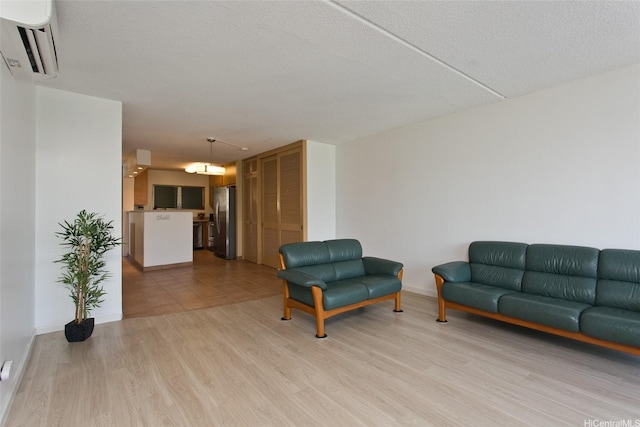 1717 Ala Wai Blvd Unit 505, Honolulu, HI 96815 - living area with a wall mounted air conditioner and light wood-type flooring