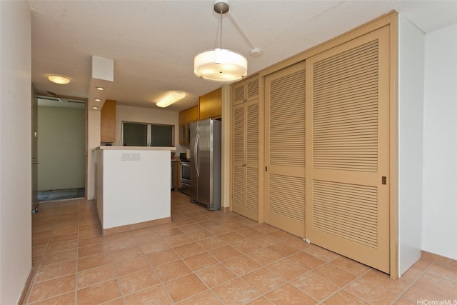 1717 Ala Wai Blvd Unit 505, Honolulu, HI 96815 - kitchen featuring stainless steel appliances, light tile patterned floors, and decorative light fixtures