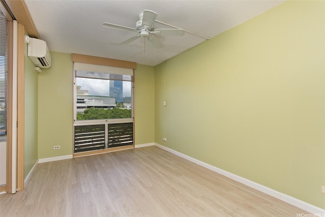 1717 Ala Wai Blvd Unit 505, Honolulu, HI 96815 - unfurnished room featuring a wall mounted air conditioner, light wood finished floors, and a ceiling fan
