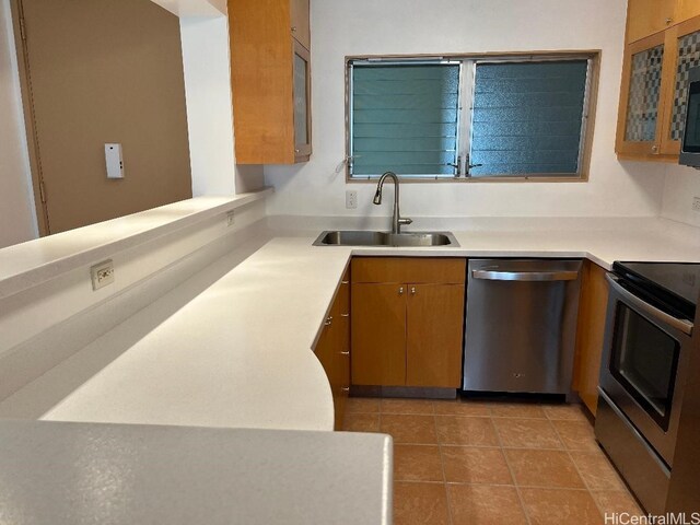 1717 Ala Wai Blvd Unit 505, Honolulu, HI 96815 - kitchen with stainless steel appliances, light countertops, brown cabinets, and glass insert cabinets
