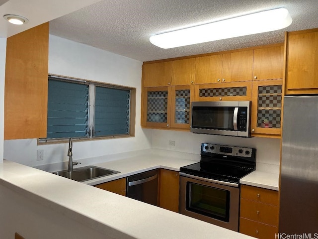 1717 Ala Wai Blvd Unit 505, Honolulu, HI 96815 - kitchen featuring stainless steel appliances, brown cabinets, a textured ceiling, glass insert cabinets, and light countertops