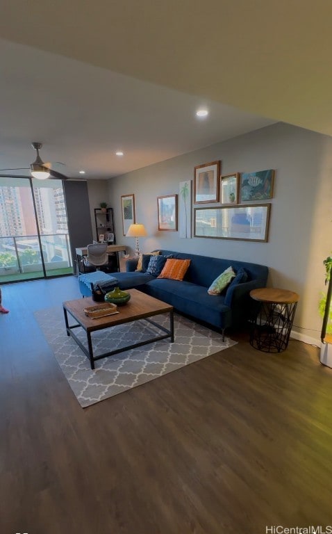 living room with expansive windows, hardwood / wood-style floors, and ceiling fan