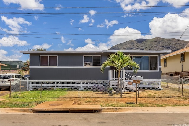 view of front facade with a fenced front yard and a mountain view