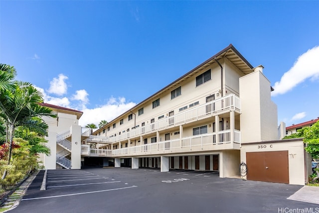 view of building exterior with uncovered parking