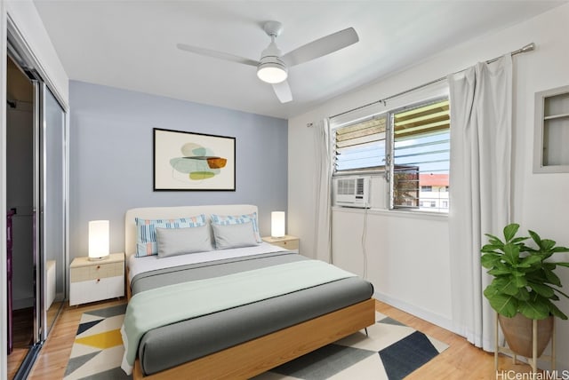 bedroom featuring light wood-type flooring, a closet, and ceiling fan