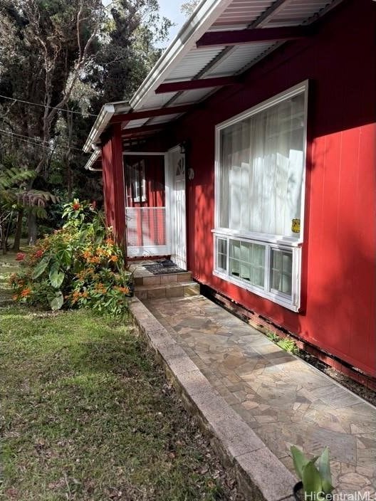 entrance to property with a lawn