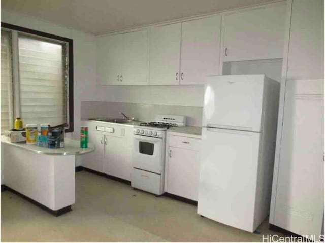 kitchen featuring white cabinetry, white appliances, and sink