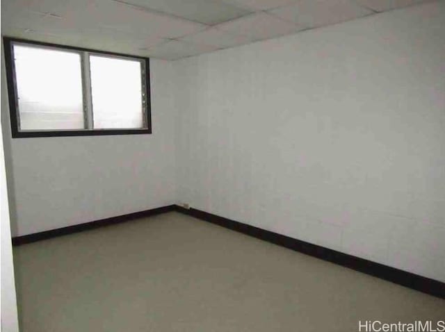 unfurnished room with a drop ceiling