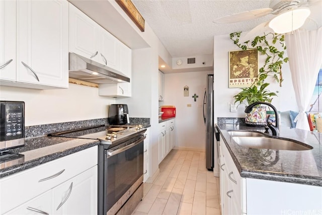 kitchen with sink, a textured ceiling, light wood-type flooring, stainless steel appliances, and white cabinets