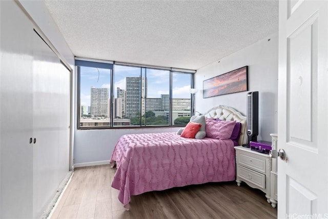 bedroom featuring a textured ceiling and light wood-type flooring