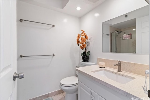 bathroom with tile patterned flooring, vanity, walk in shower, and toilet