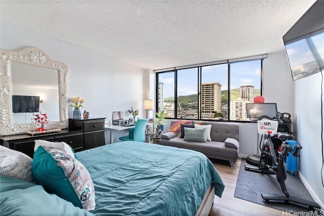 bedroom featuring light hardwood / wood-style flooring and a textured ceiling