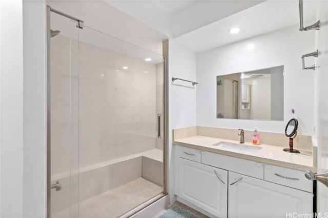 bathroom with vanity and a shower with door