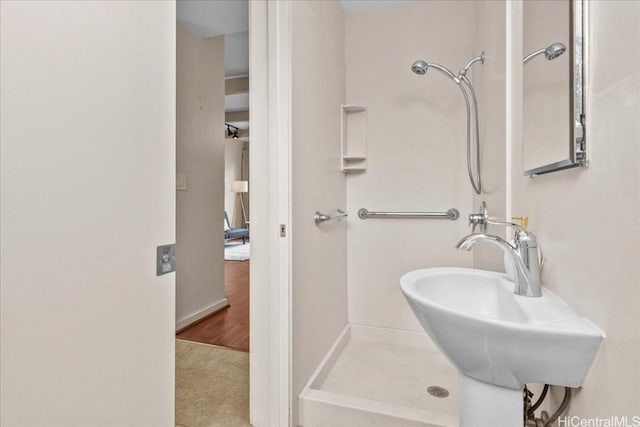 bathroom with sink and a shower