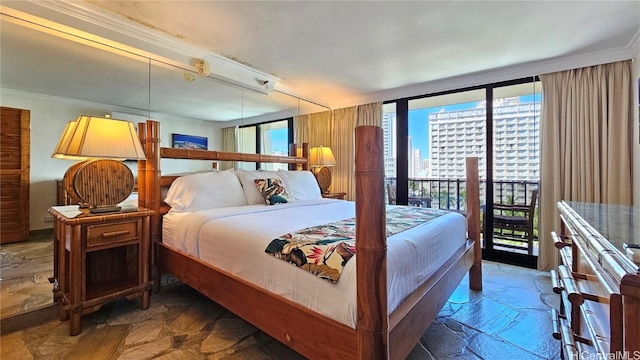 bedroom featuring expansive windows and crown molding