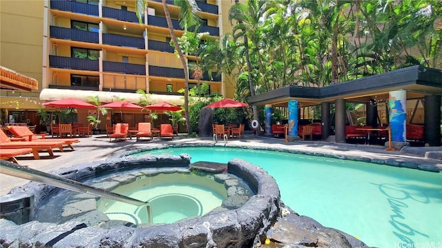 view of pool featuring a hot tub