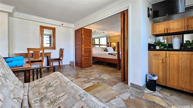 interior space with ornamental molding and a closet