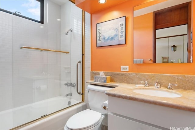 full bathroom with vanity, combined bath / shower with glass door, and toilet