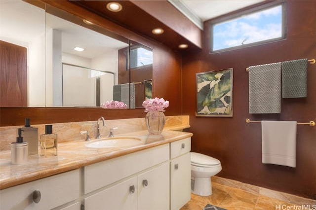 bathroom with vanity, an enclosed shower, and toilet