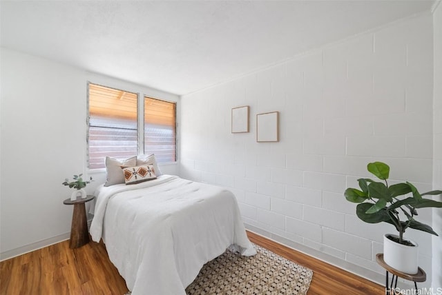 bedroom with hardwood / wood-style floors