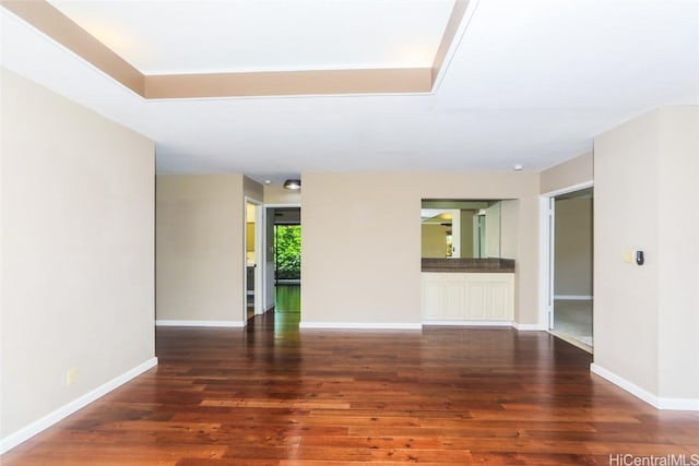 empty room with wood finished floors and baseboards