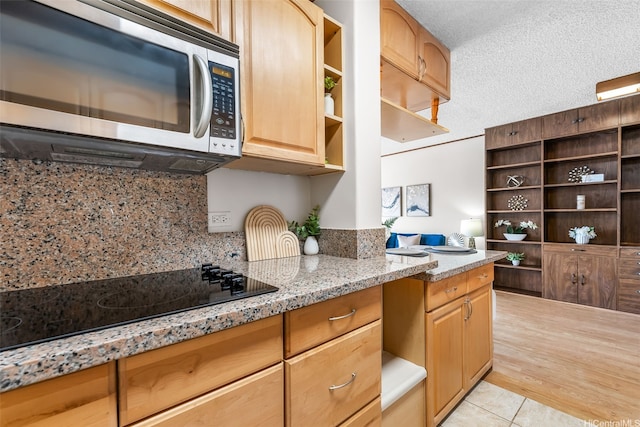 775 Kinalau Pl Unit 1907, Honolulu, HI 96813 - kitchen featuring stainless steel microwave, open shelves, black electric cooktop, backsplash, and a textured ceiling