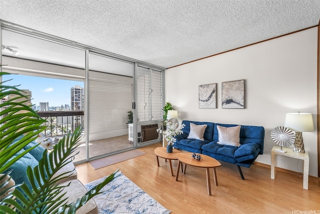 775 Kinalau Pl Unit 1907, Honolulu, HI 96813 - living area with a textured ceiling, light wood-style floors, a view of city, and crown molding