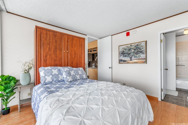 775 Kinalau Pl Unit 1907, Honolulu, HI 96813 - bedroom featuring ornamental molding, wood finished floors, a textured ceiling, and baseboards