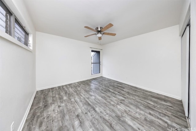 unfurnished bedroom featuring a ceiling fan, a closet, baseboards, and wood finished floors