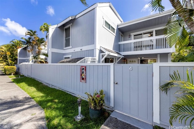 view of property exterior featuring a fenced front yard and a gate