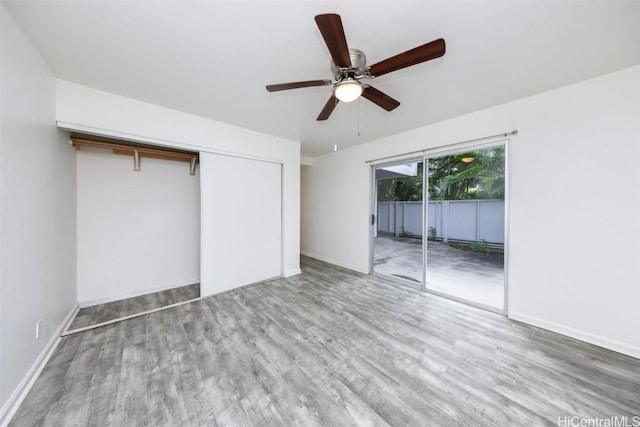 unfurnished bedroom with a closet, access to outside, ceiling fan, and light hardwood / wood-style flooring